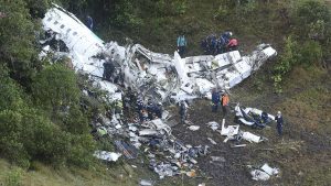 Rescue workers carry a body away from he wreckage of a chartered airplane that crashed in La Union, a mountainous area outside Medellin, Colombia, Tuesday , Nov. 29, 2016. The plane was carrying the Brazilian first division soccer club Chapecoense team that was on it's way for a Copa Sudamericana final match against Colombia's Atletico Nacional. (AP Photo/Luis Benavides)